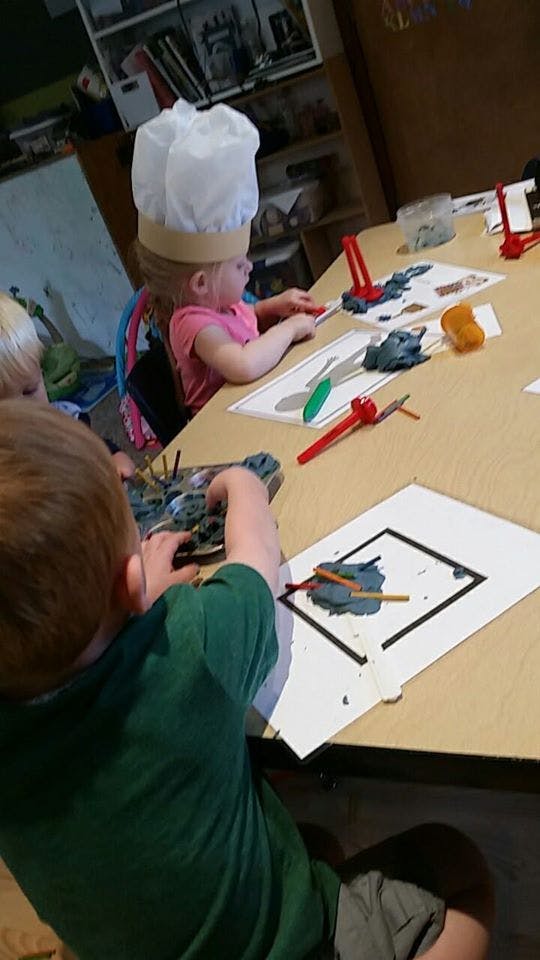 Children playing with modeling clay at a table
