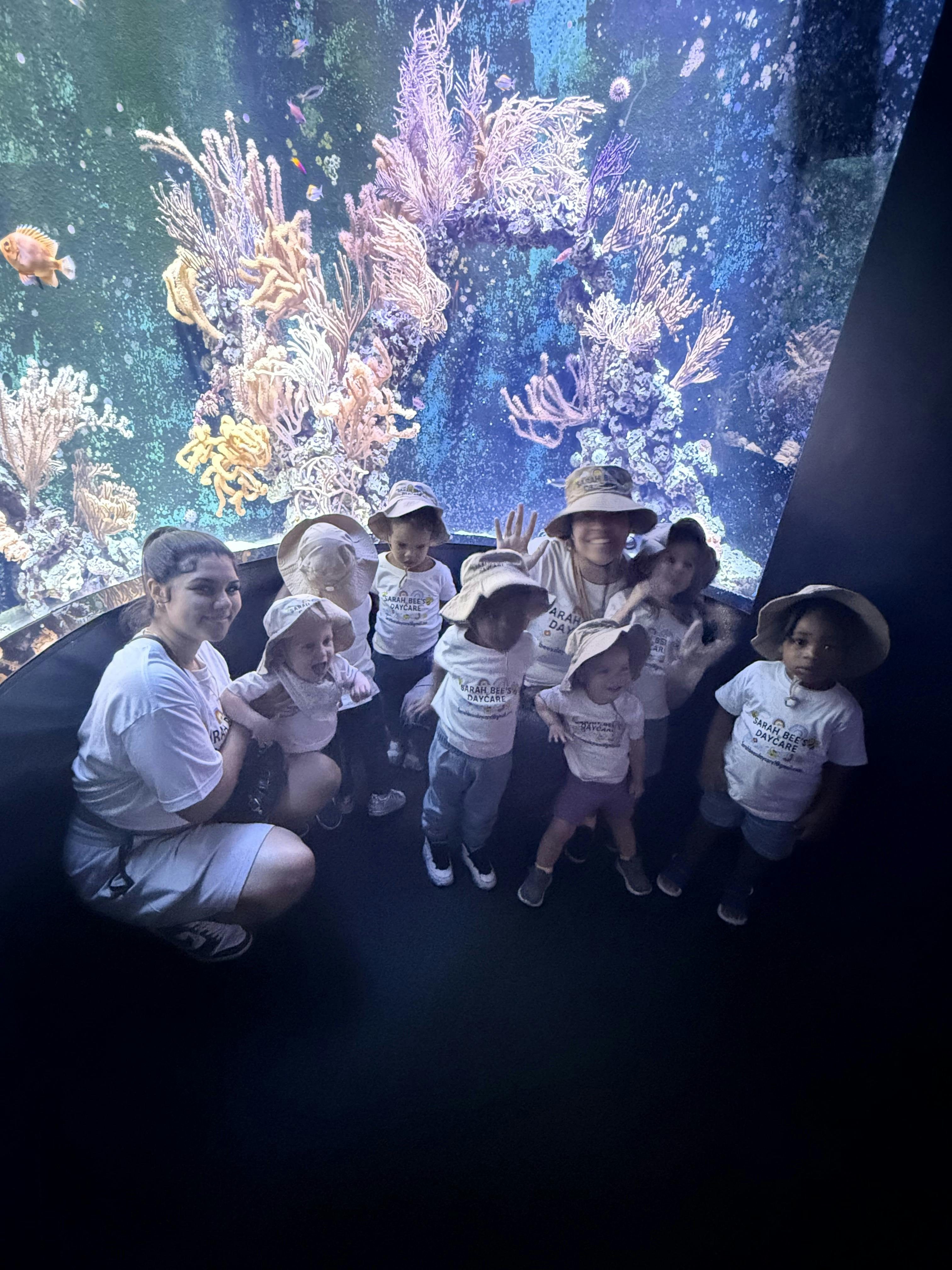 Group in matching t-shirts and hats at an aquarium