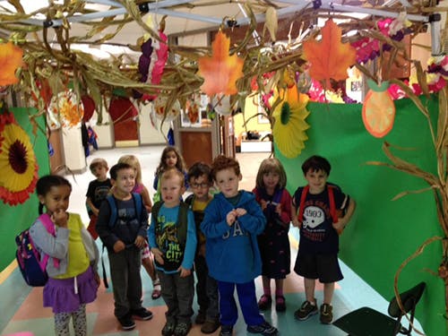 Group of children standing under fall decorations