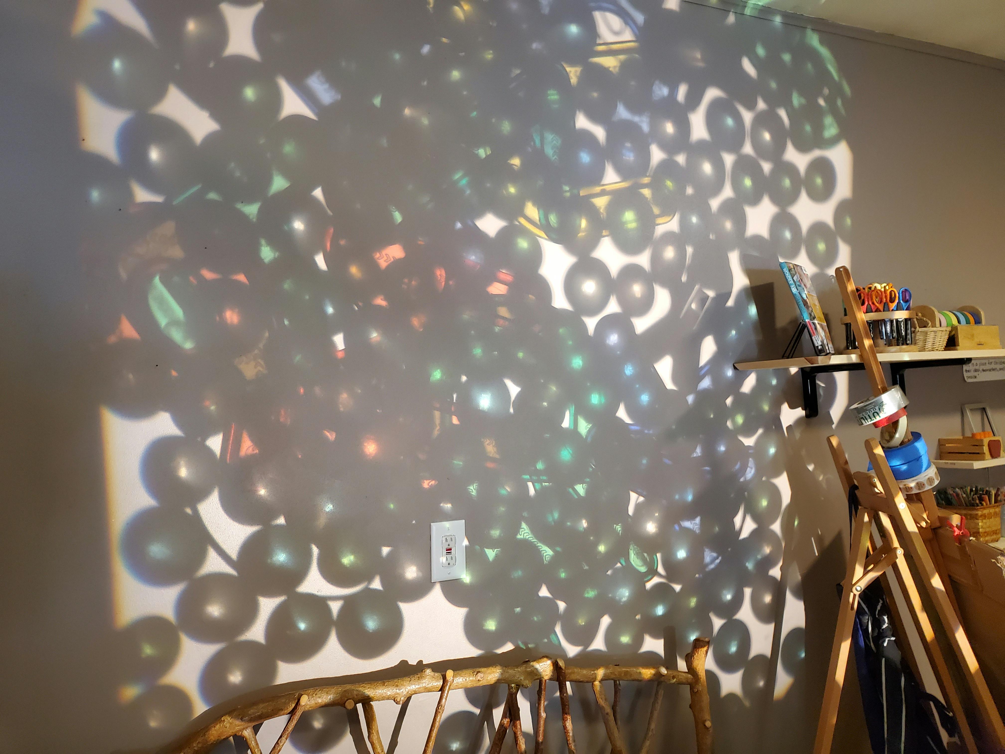 Light reflections creating circular patterns on a wall