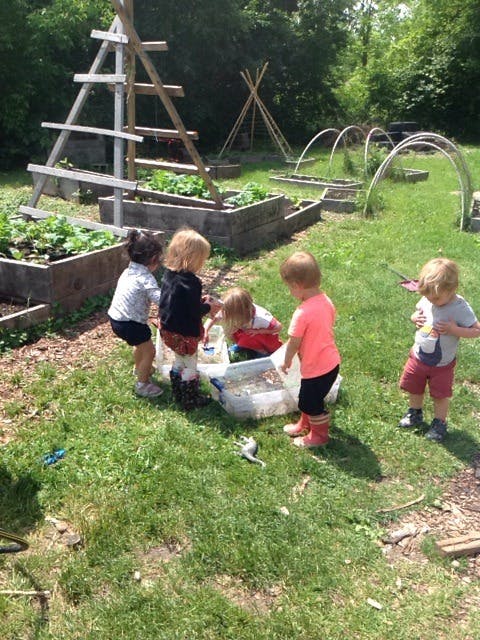 Children playing with water in a garden