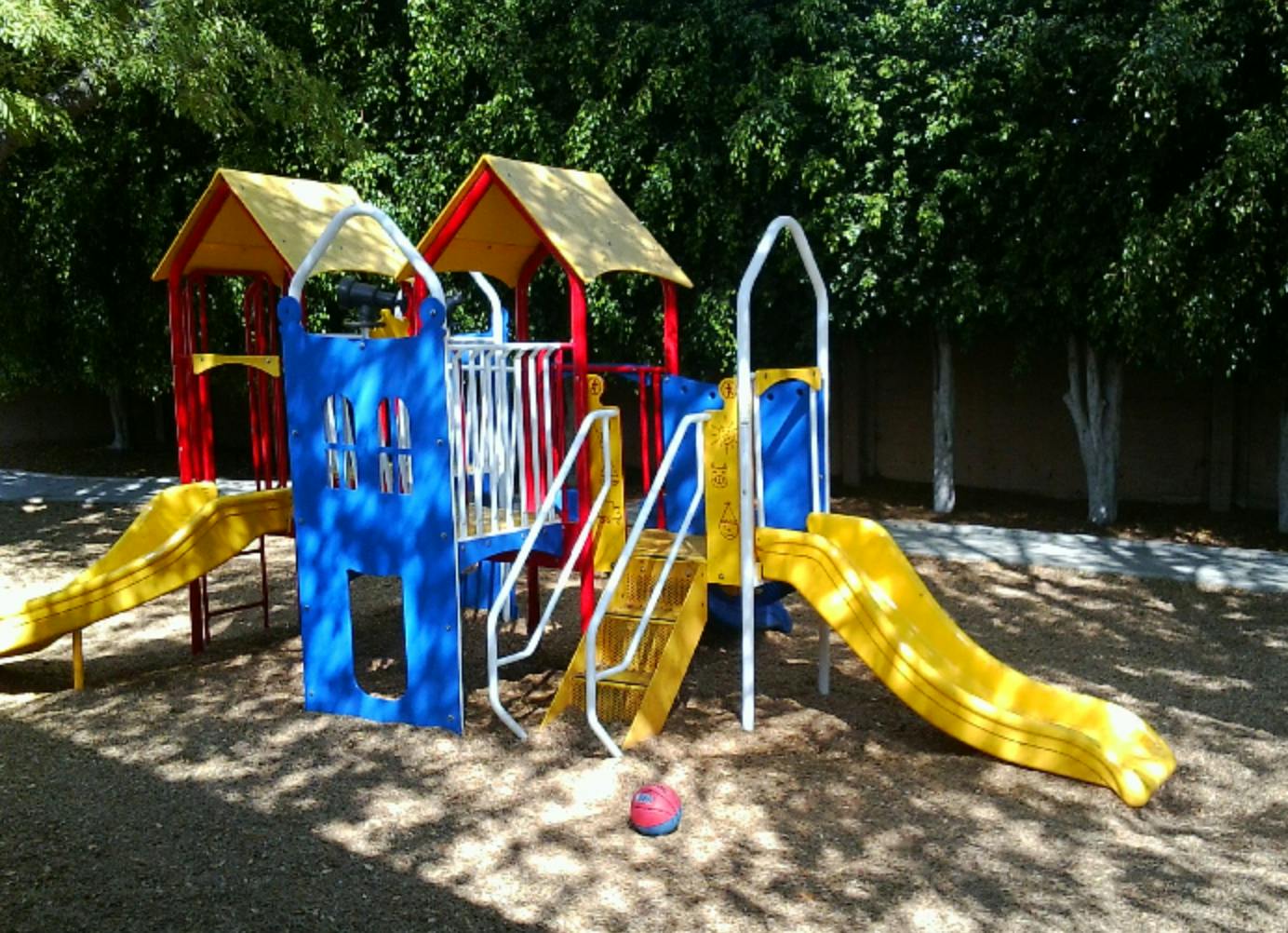 Colorful playground structure with slides and stairs