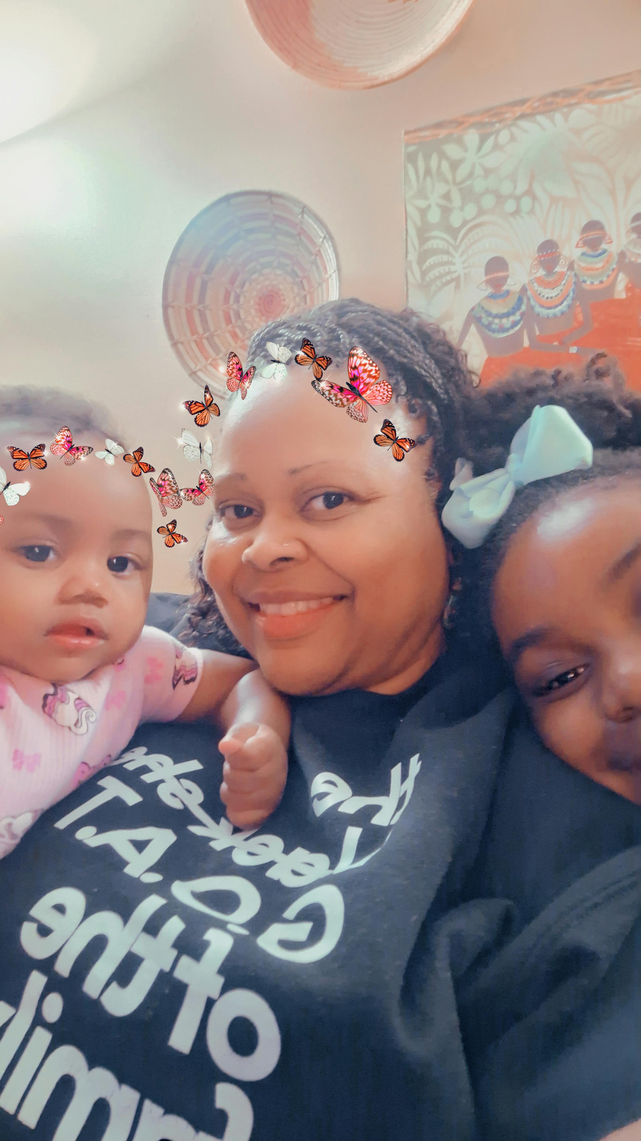 Adult with two children posing for a selfie