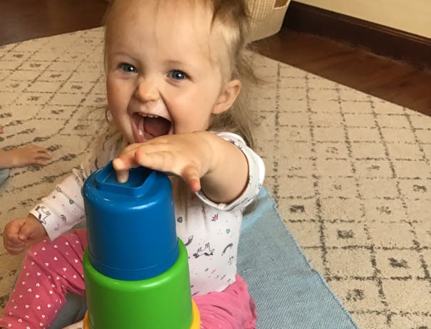 Child playing with stacking cups