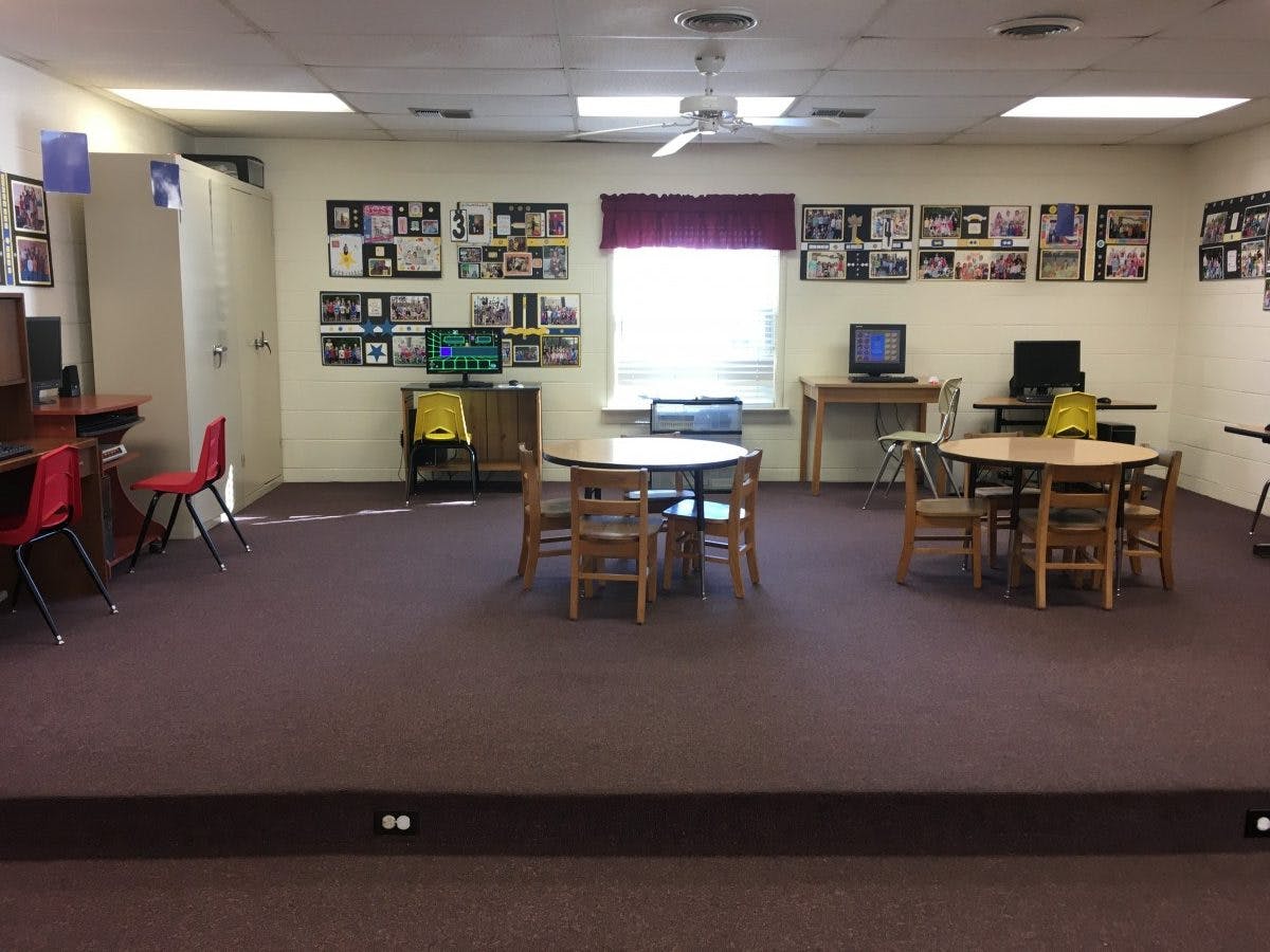 Room with tables, chairs, and computers