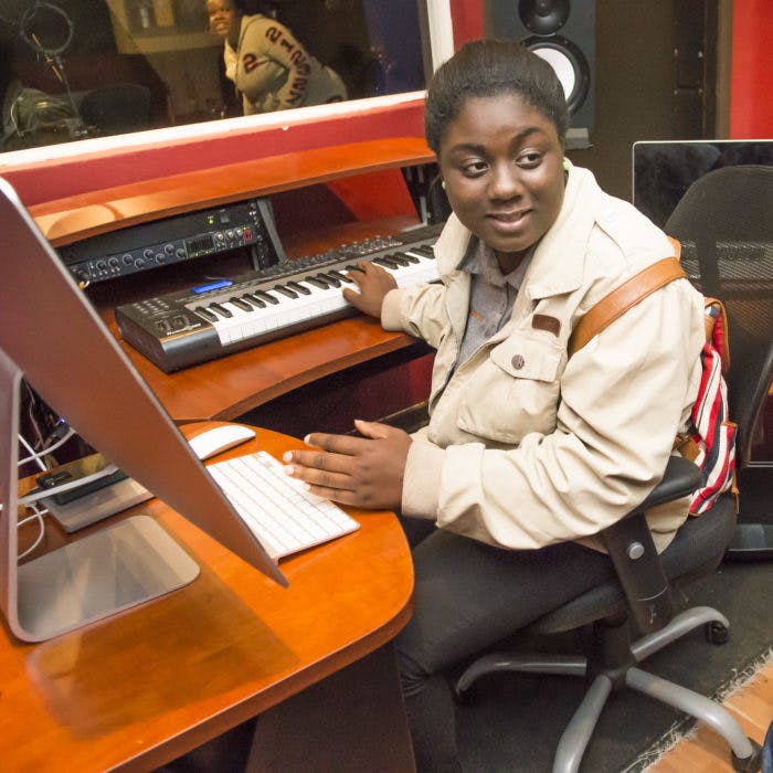 Person at a desk with a keyboard and computer