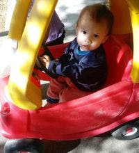 Child in a toy car