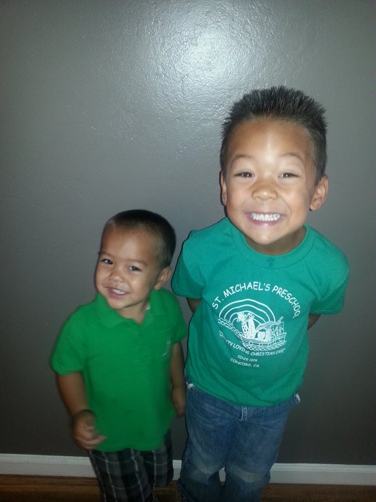 Two children standing and smiling