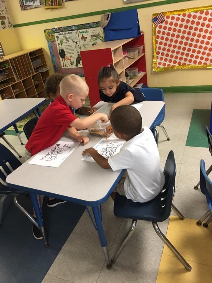 Children at a table in a classroom