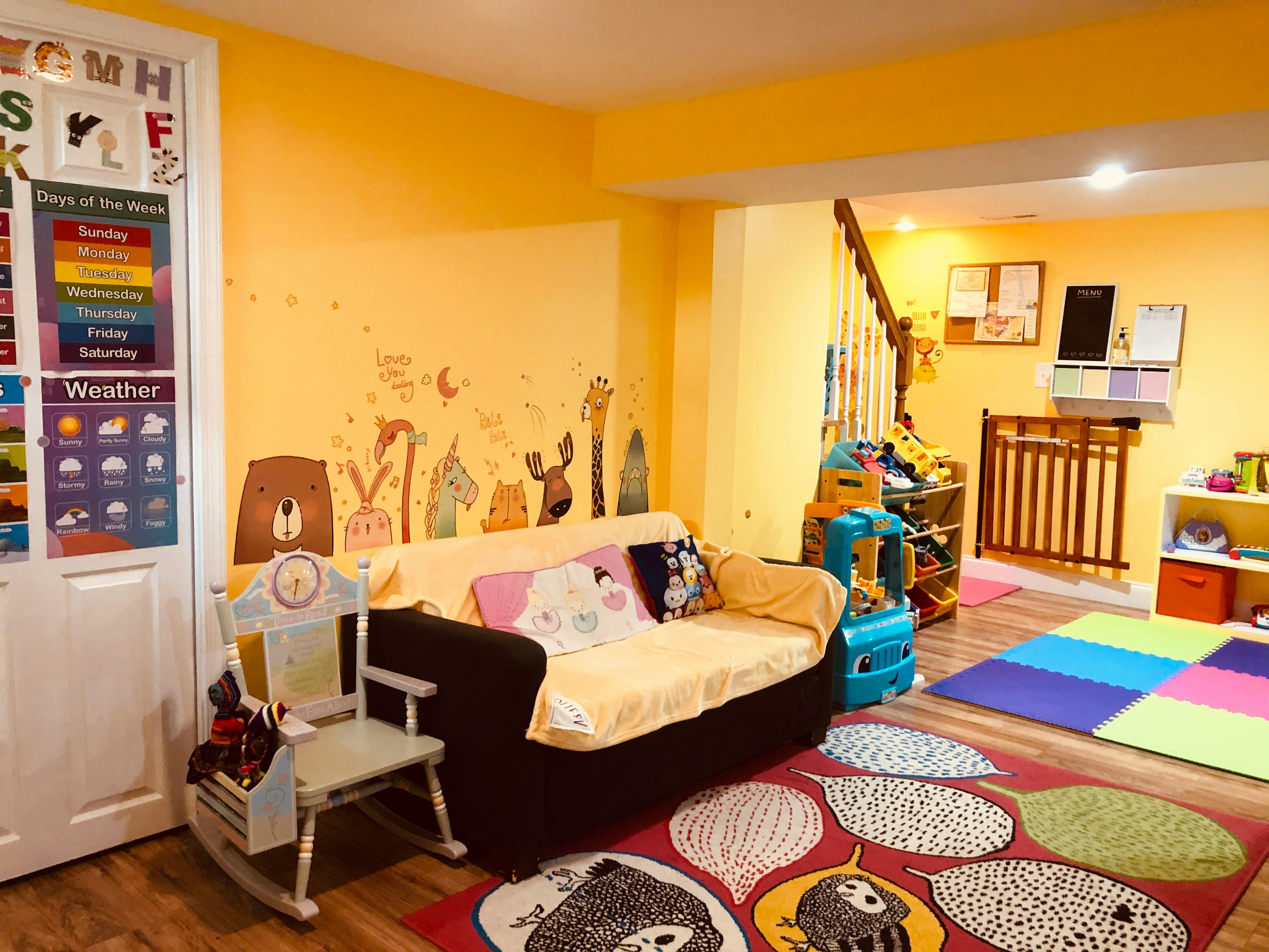 Playroom with a sofa, rocking chair, and colorful rugs