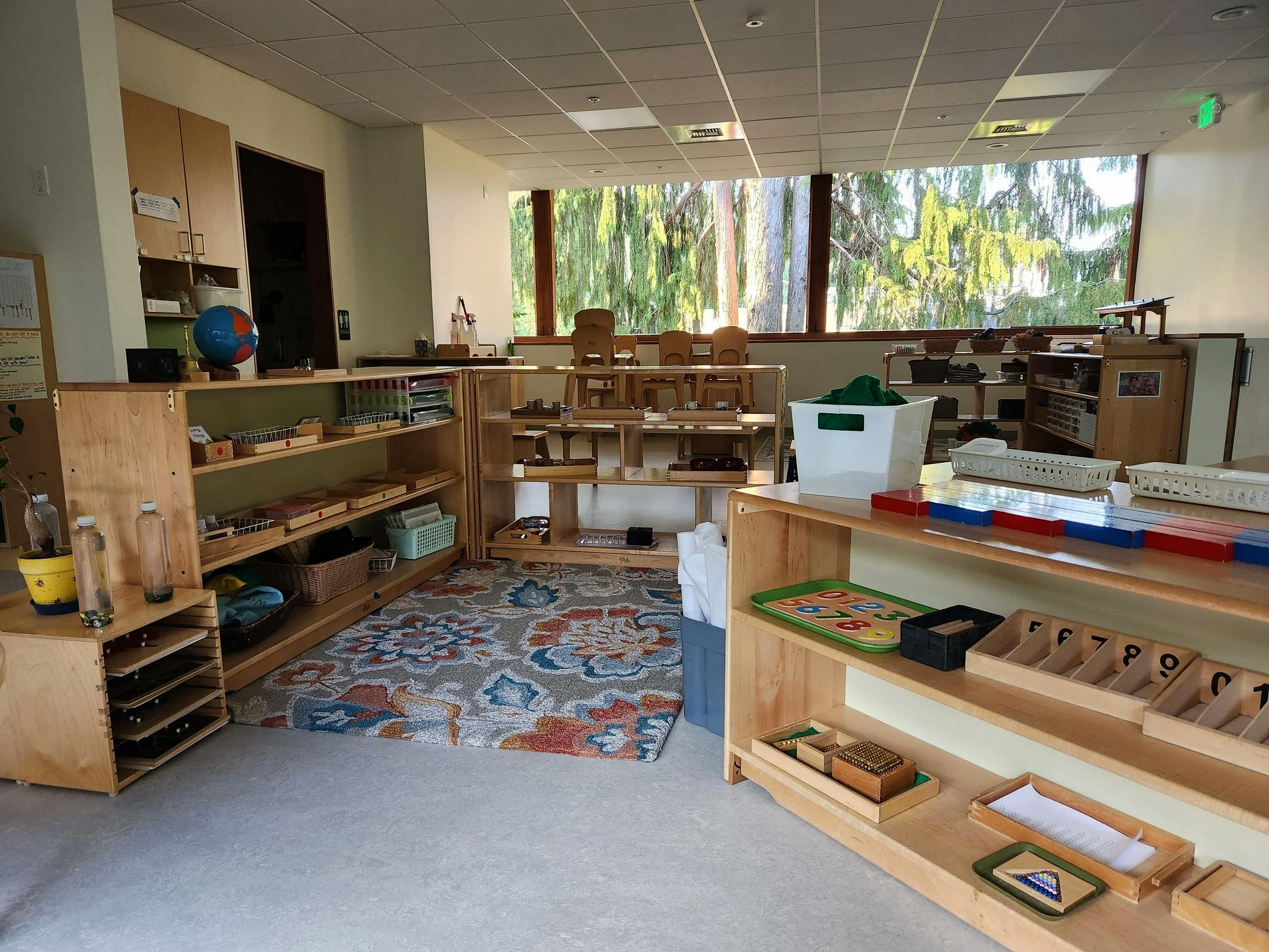 Classroom filled with wooden shelves and educational materials for children