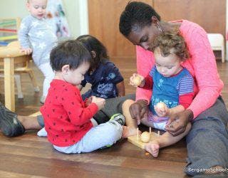 Adult and children playing with toys on the floor
