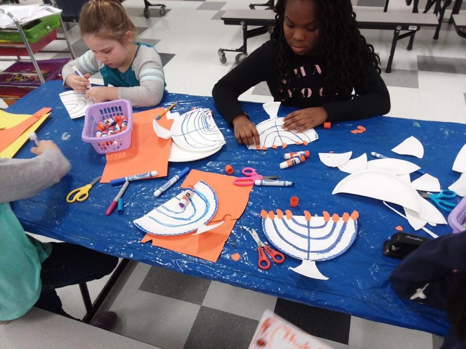 Two children making crafts at a table