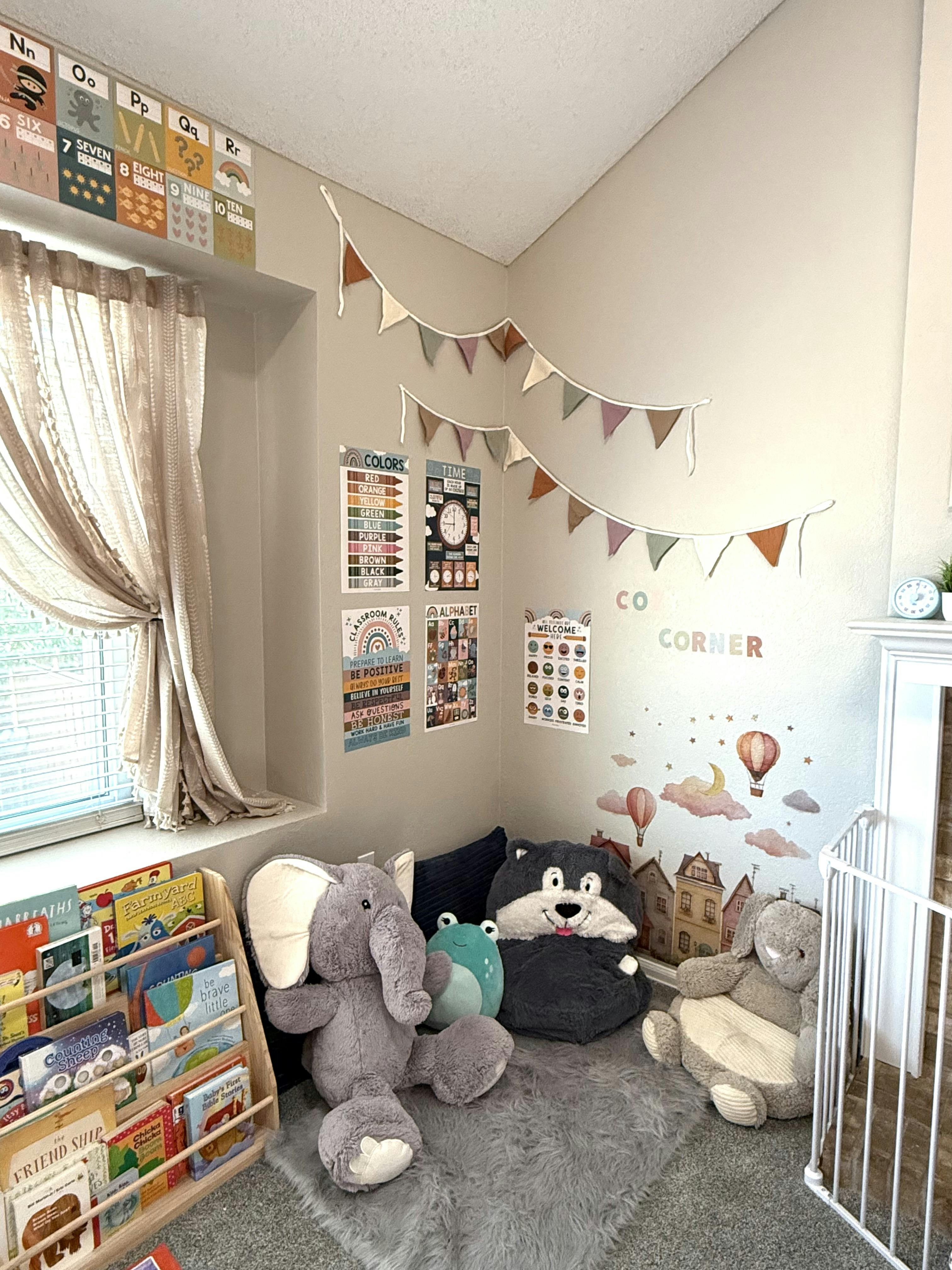 Cozy corner in a room featuring plush toys and children's books on a rack