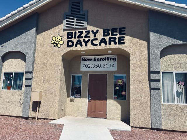 Bizzy Bee Daycare building with "Now Enrolling" sign