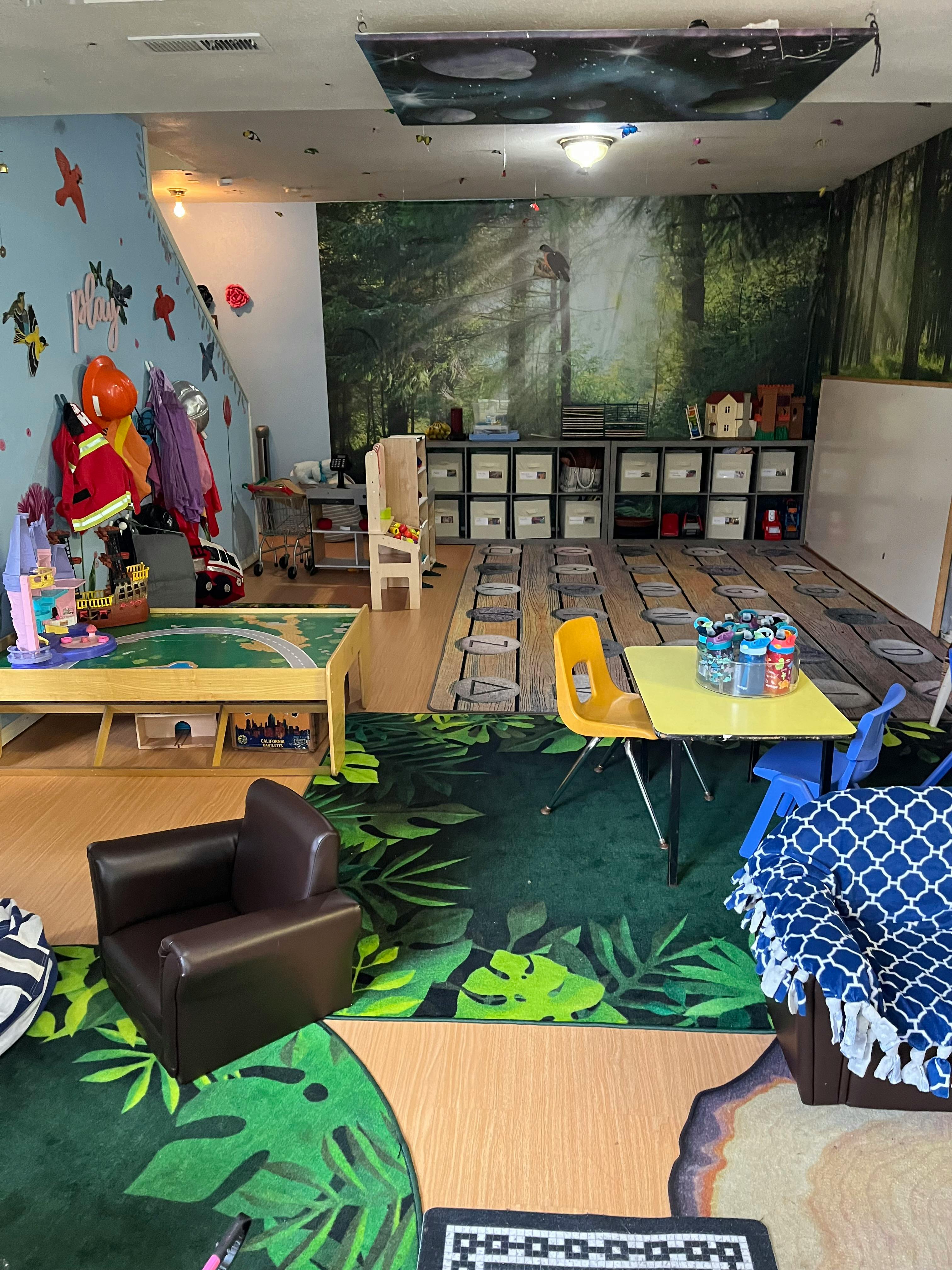 Playroom with tables, chairs, and storage shelves