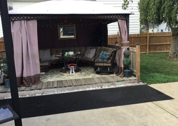Outdoor gazebo with furniture on a wooden deck
