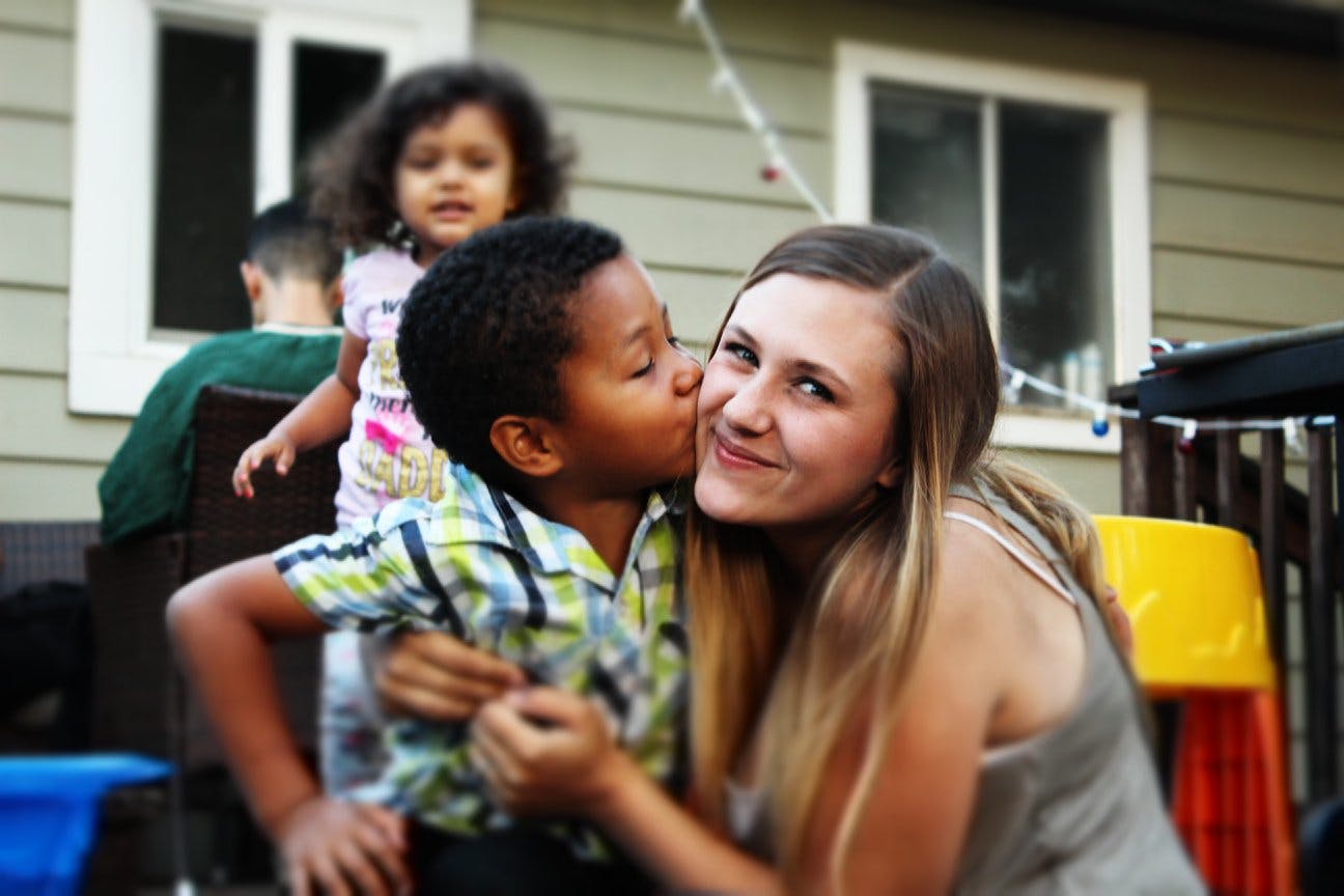 Child kissing a person on the cheek
