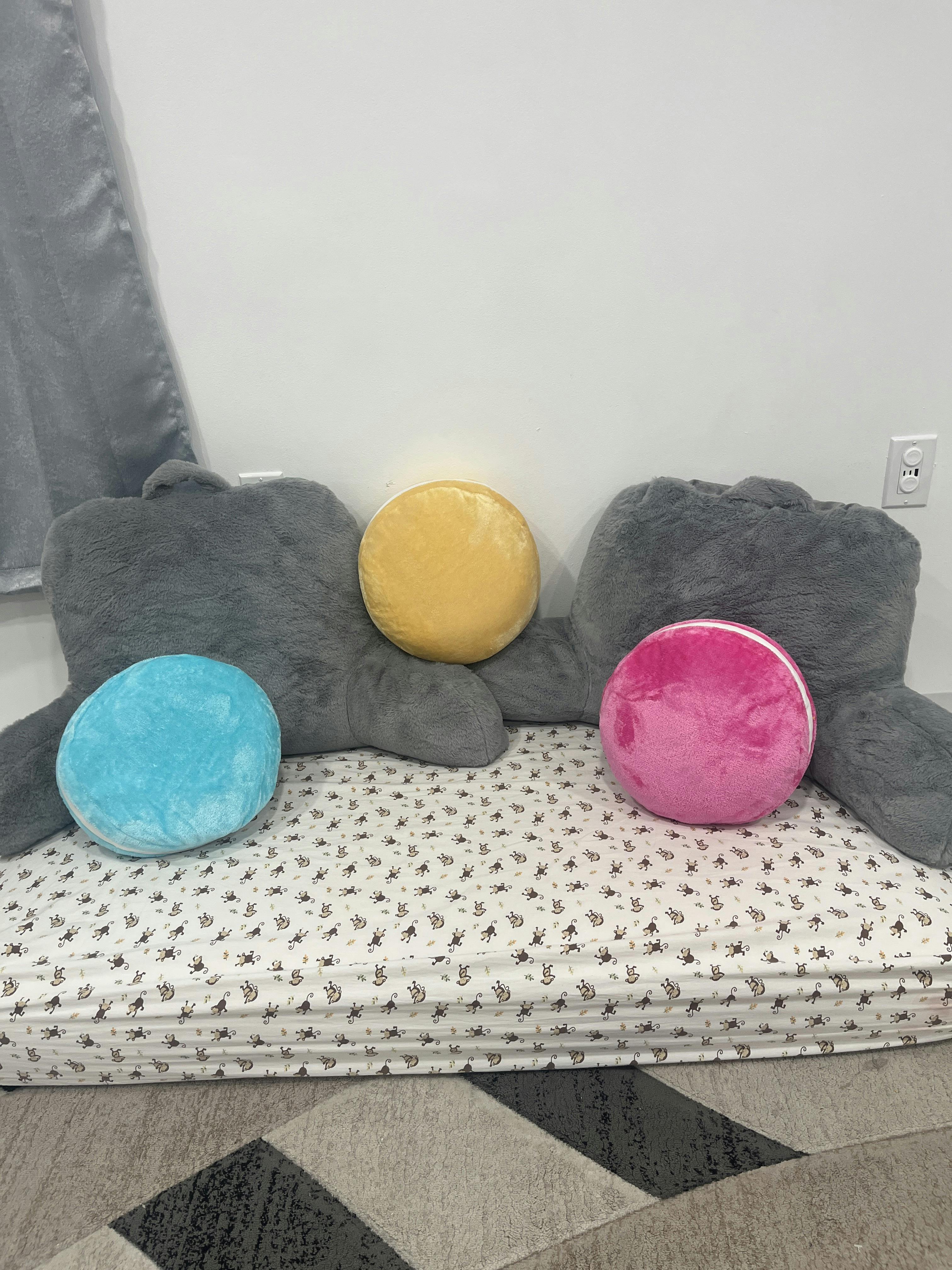 Decorative pillows on a mattress with a monkey print sheet