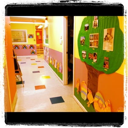 Hallway with colorful walls and decorations, including a tree mural
