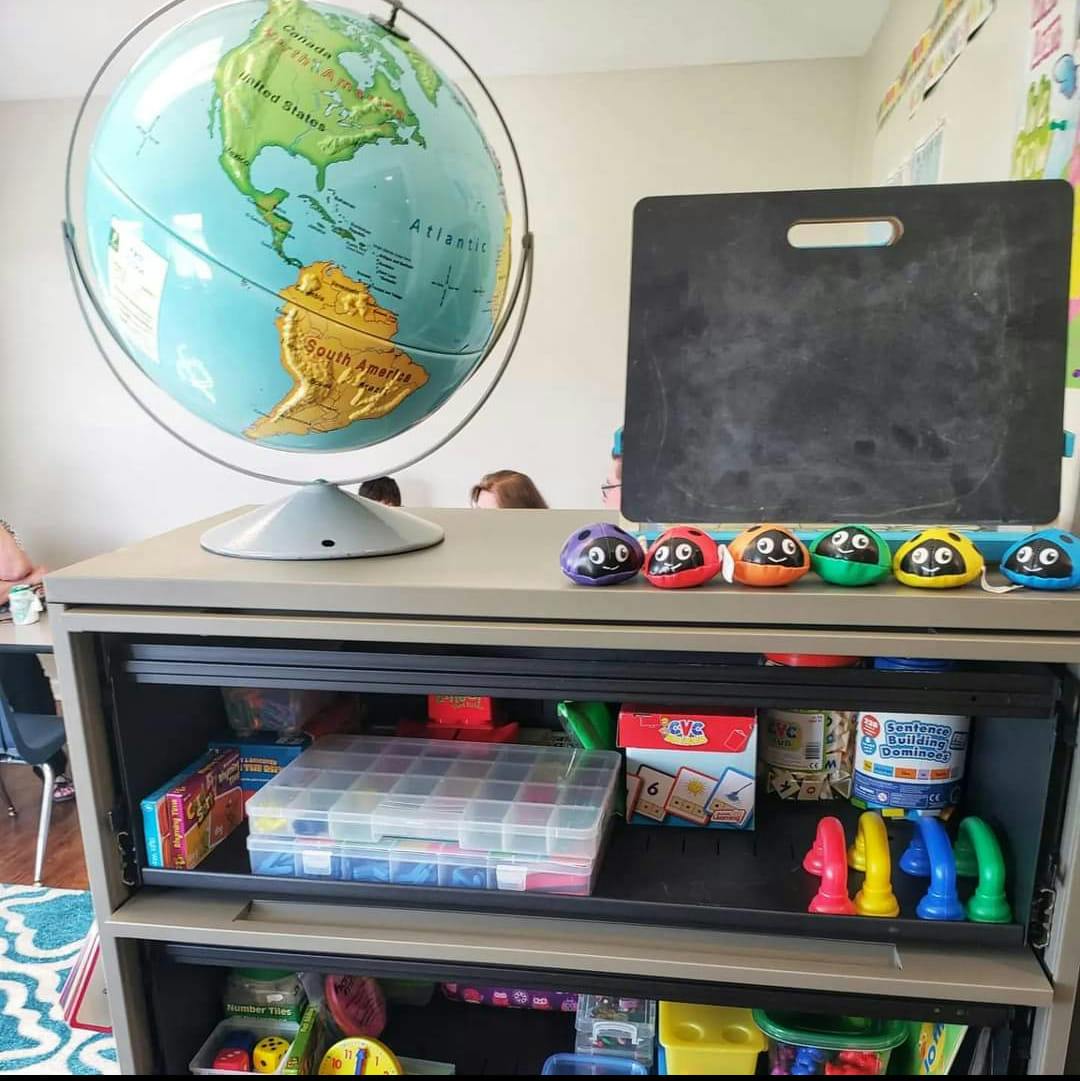 Globe and chalkboard on a shelf with colorful toys