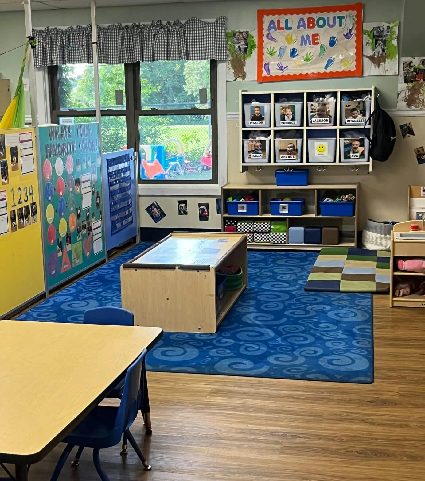 An empty classroom with colorful learning displays and storage cubbies