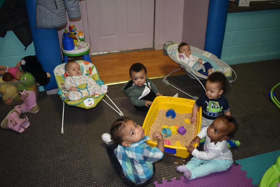 Multiple children playing with a sand table