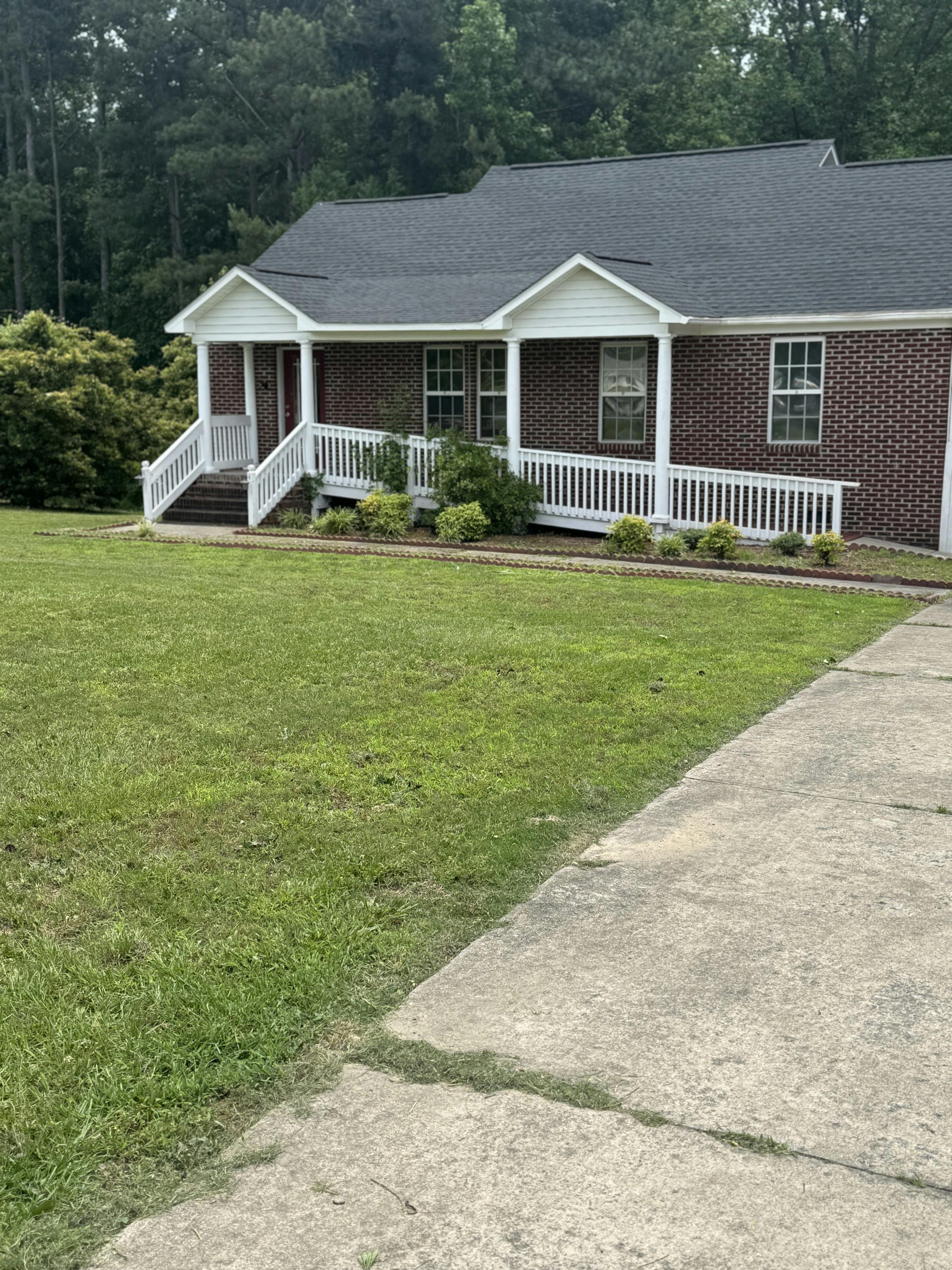 Brick house with white porch railing and ramp