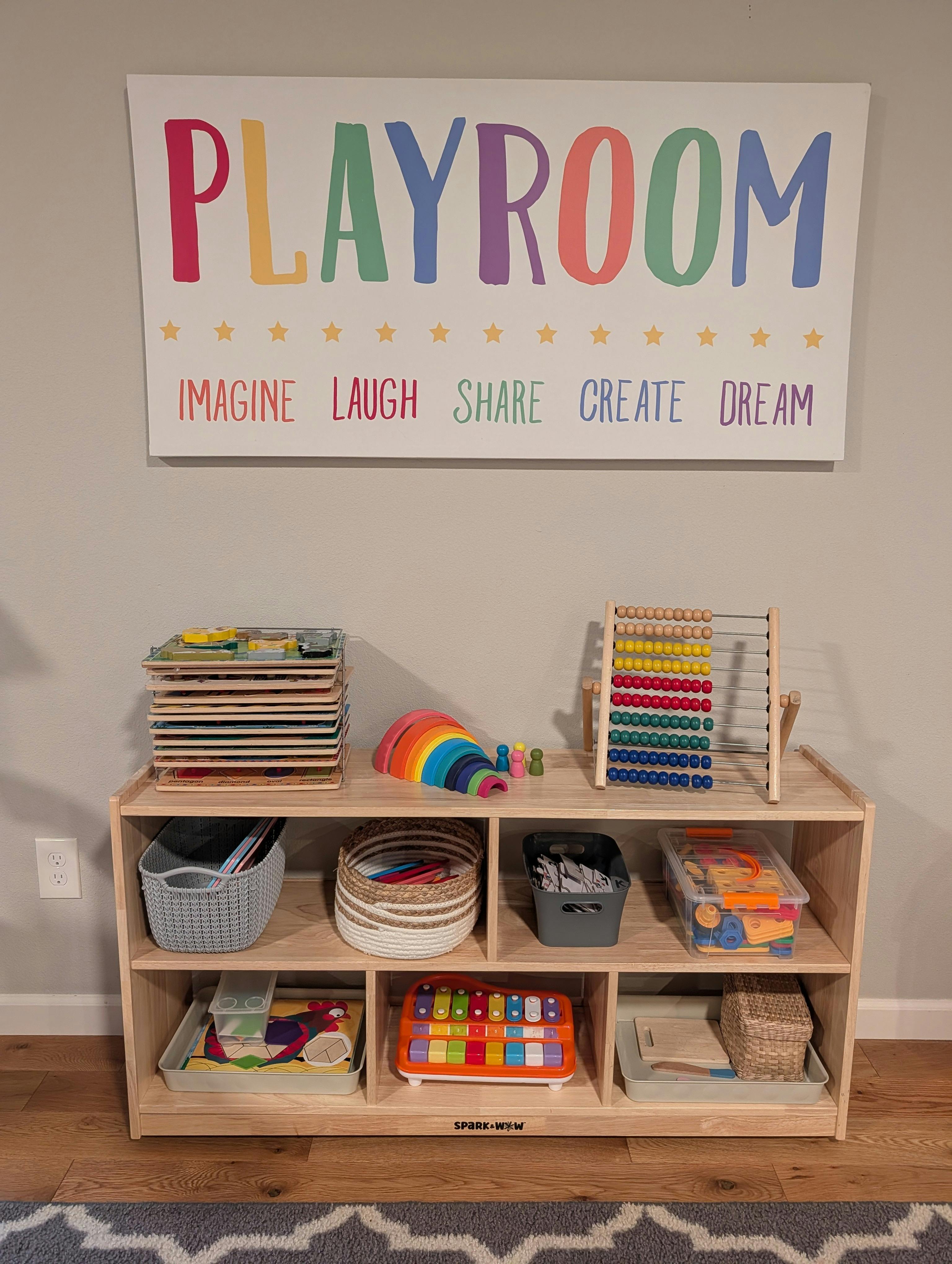 Wooden toy shelf with educational toys and a Playroom sign on the wall
