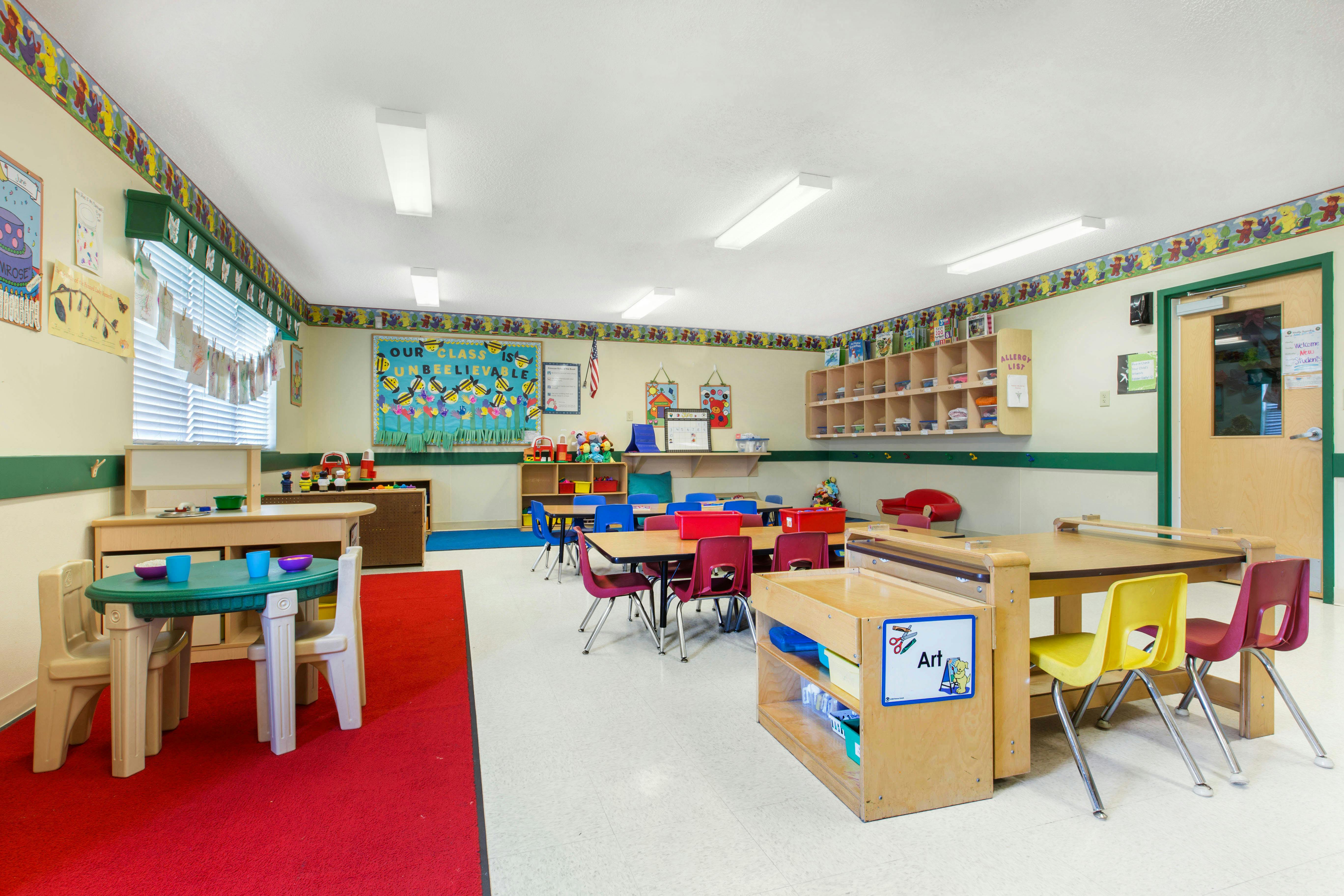 An empty colorful classroom with small tables and chairs
