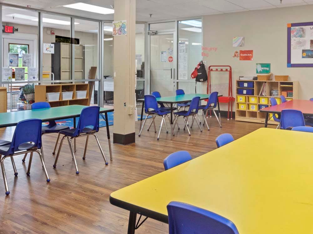 Classroom with colorful tables and blue chairs