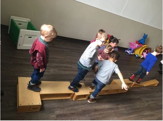 Children walking on wooden balance beams