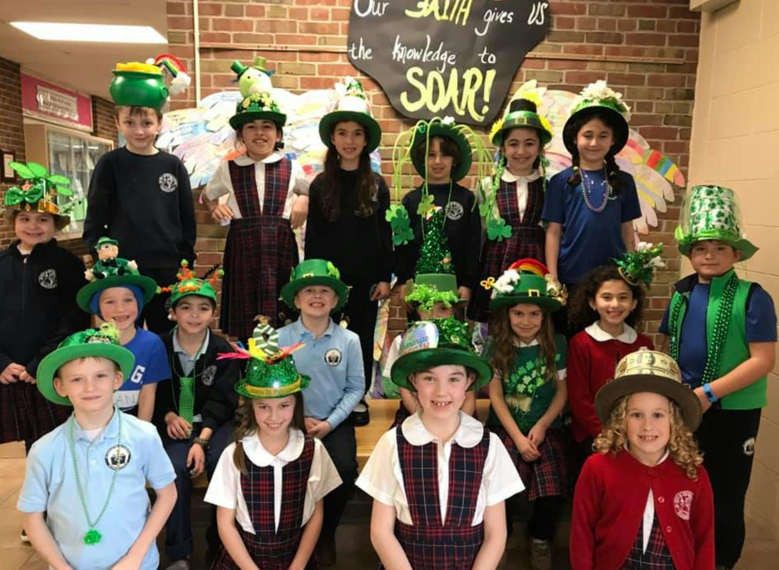 Group of children wearing green hats