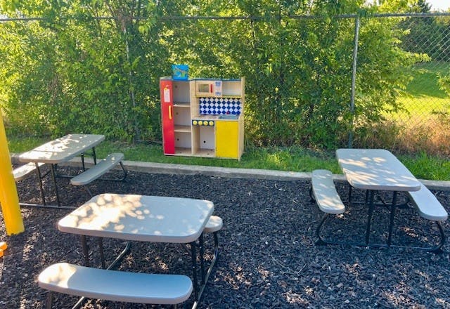 Play kitchen and picnic tables on a playground
