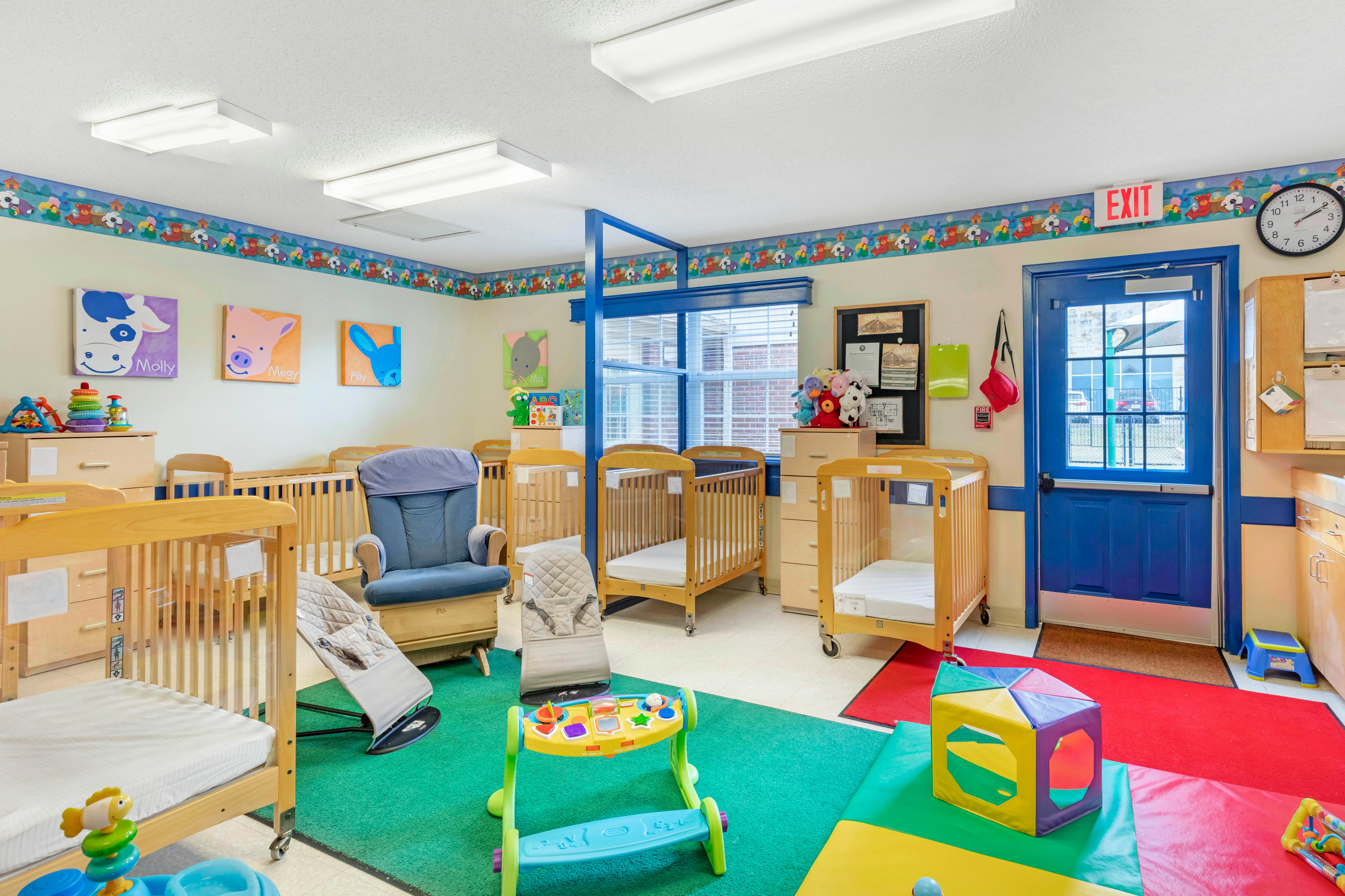 Cribs, rocking chairs, and toys in a bright childcare room