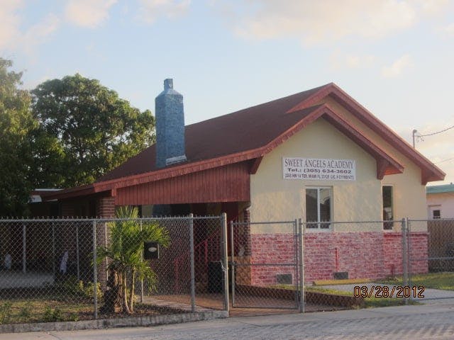 Building with a red roof and a sign that reads "SAINT ANGELA ACADEMY"