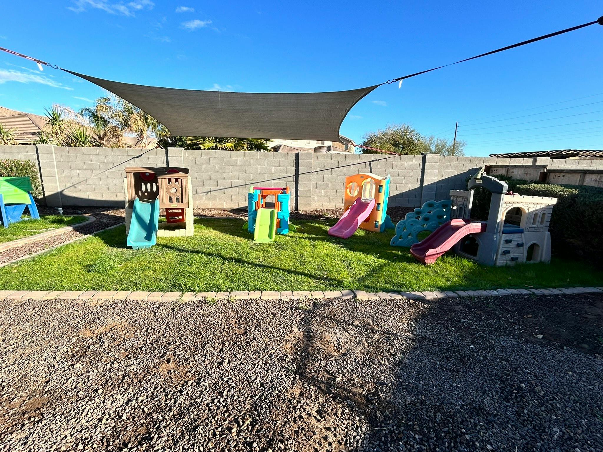 Playground with multiple colorful slides and play structures on grass