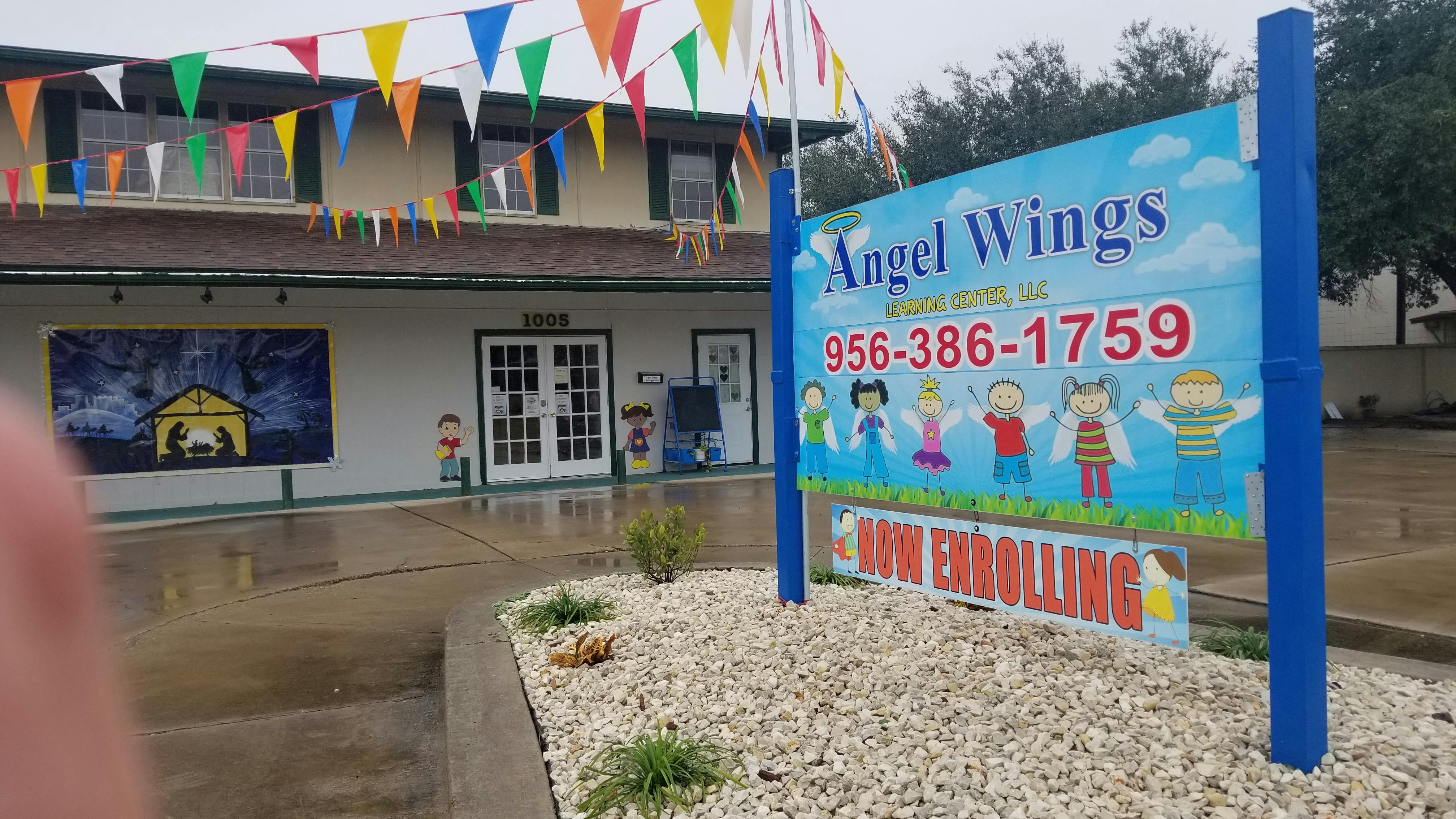 Angel Wings sign with phone number and "Now Enrolling"