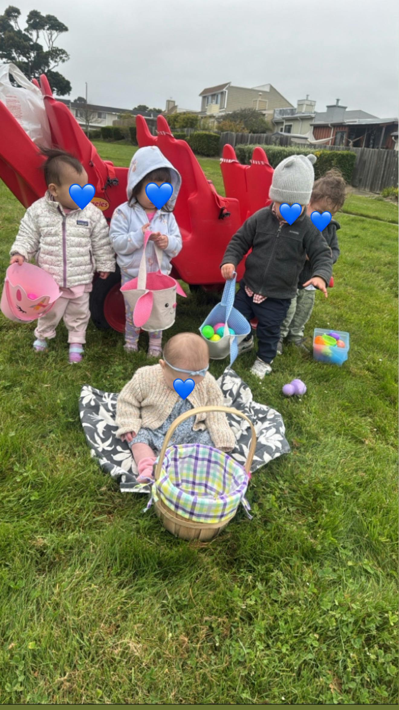Group of children holding baskets during an outdoor egg hunt