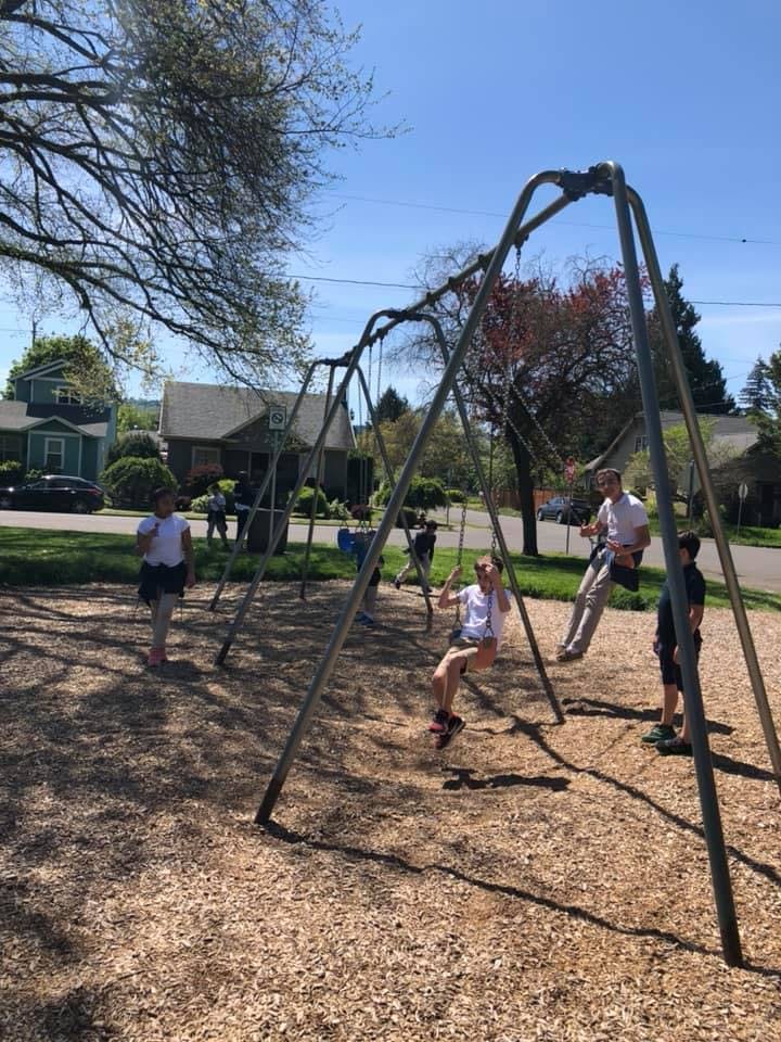 People on swings at a playground