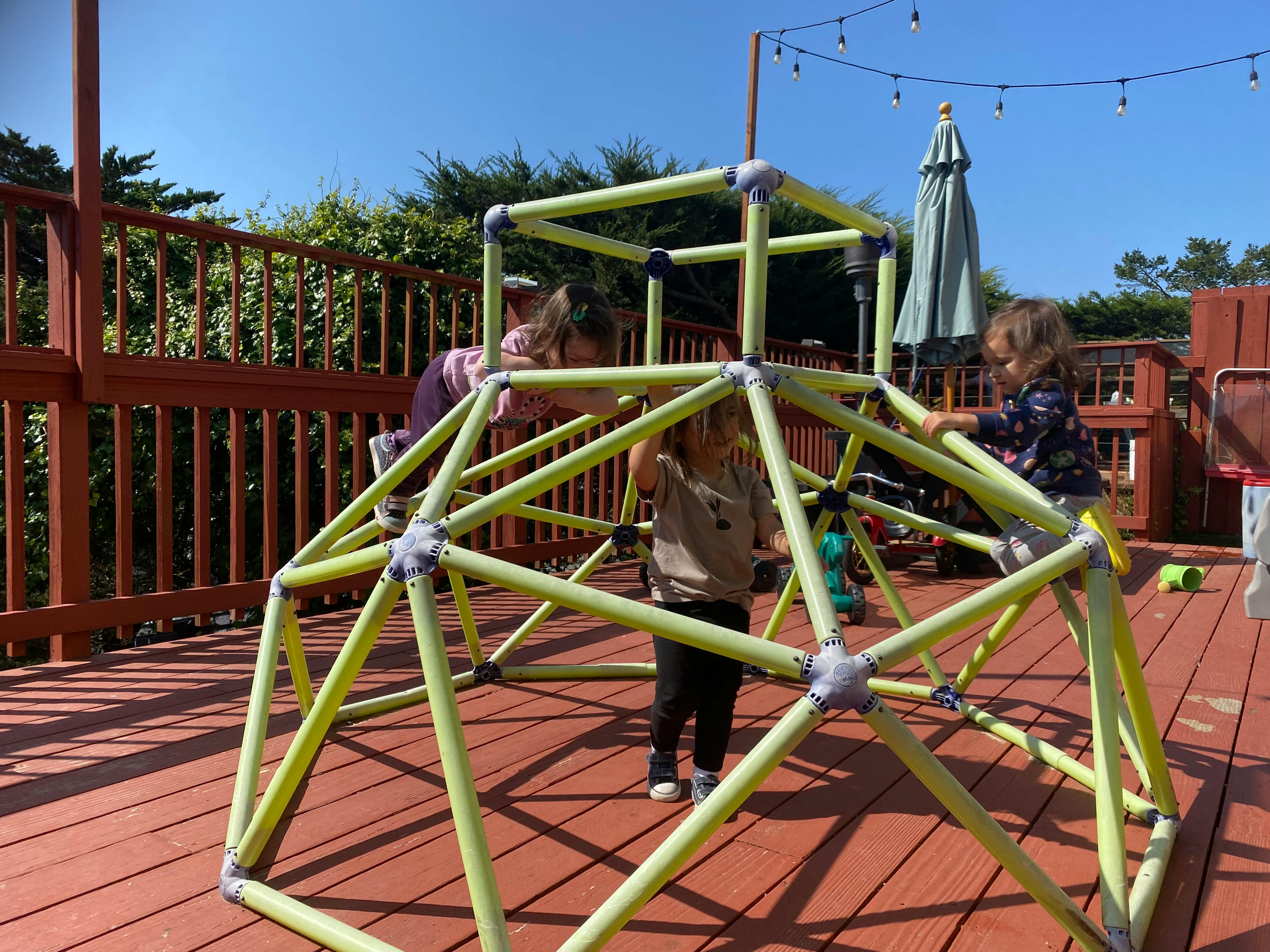Children playing on a geometric climbing dome