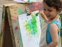 Child painting on an easel