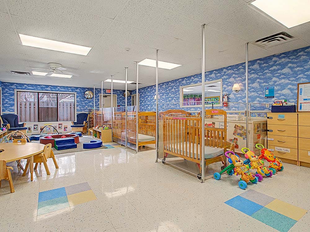 Cribs and small play area in a nursery classroom