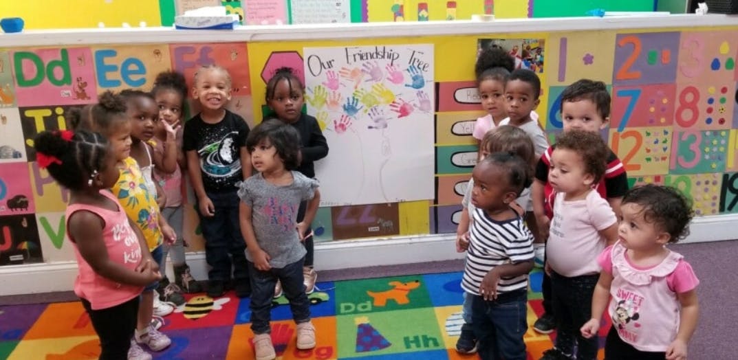 Group of children standing in a classroom