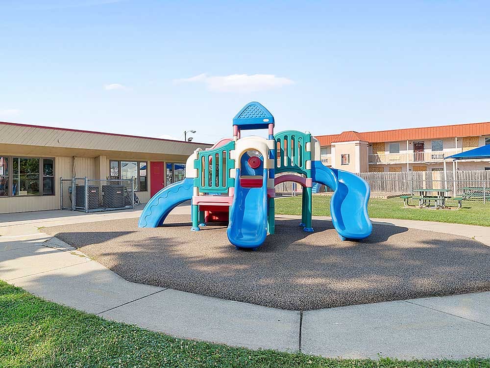 Colorful playground structure with slides on a padded surface