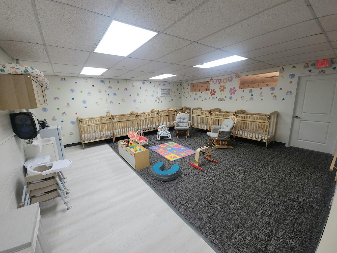 Nursery room with multiple cribs and play mats