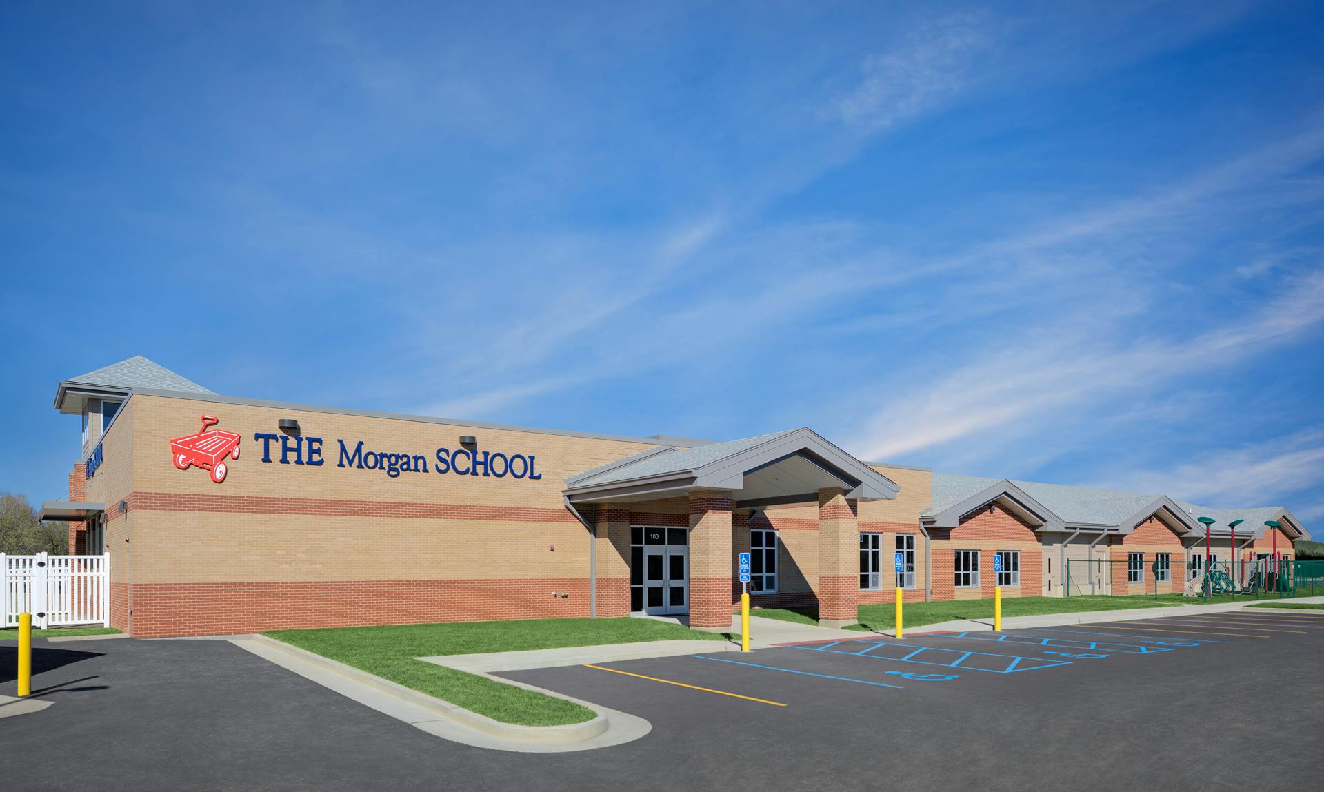 The Morgan School building exterior with parking lot and blue sky