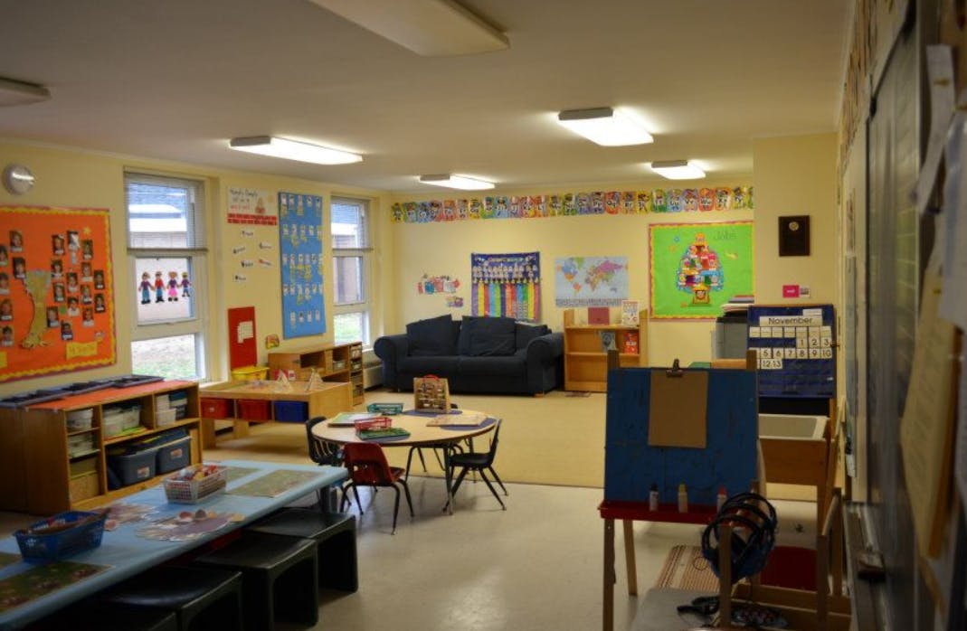 Classroom with tables, chairs, and a sofa