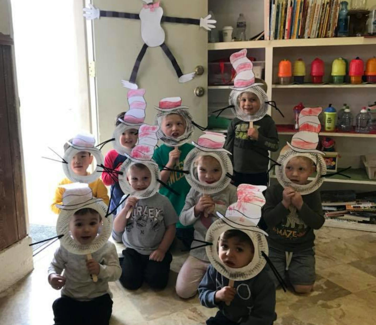 Group of children wearing paper hats and collars