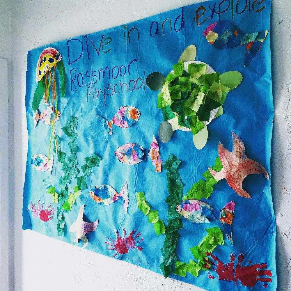 Child's ocean-themed craft project with fish, jellyfish, turtle, and starfish